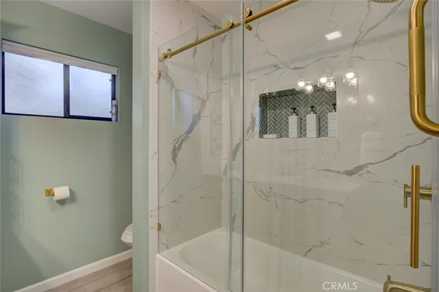 a bathroom with a bathtub and a shower