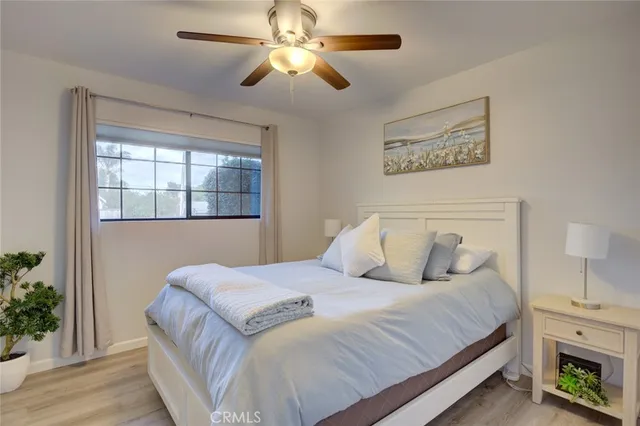 a bedroom with a large bed and a chandelier