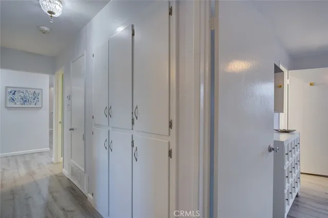 a view of a hallway with wooden floor