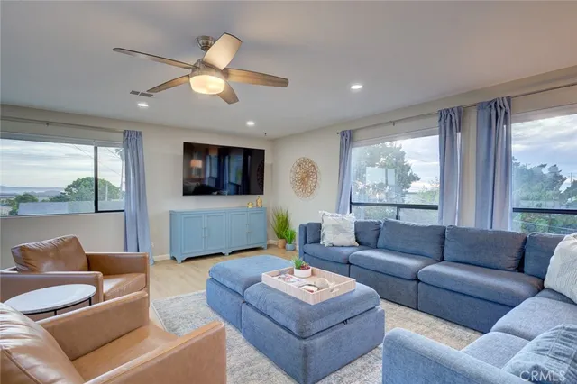 a living room with furniture and a large window