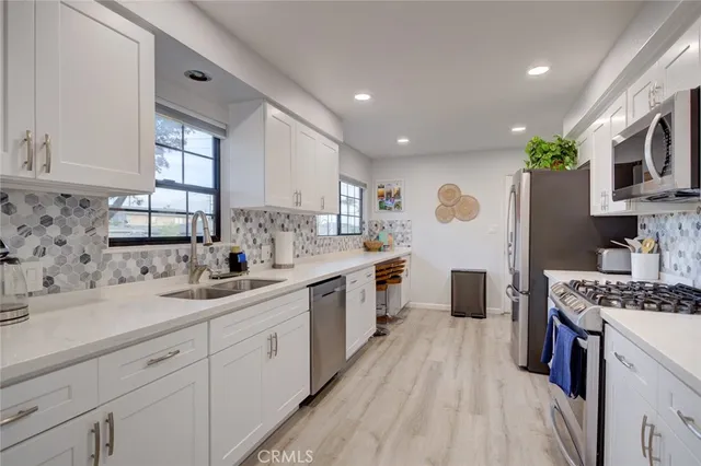 a kitchen with a sink stove and cabinets