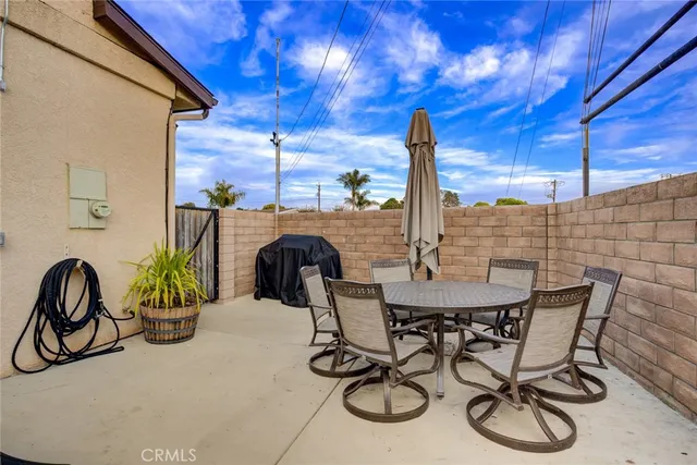 a view of an outdoor dining space with a table and chairs