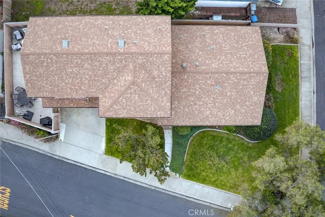 an aerial view of a house with a garden and a building