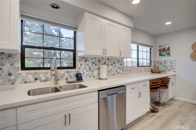 a kitchen with stainless steel appliances sink and cabinets
