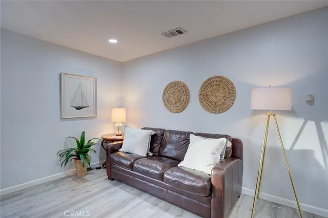 a living room with furniture and a lamp