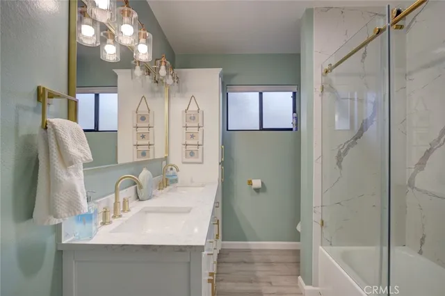a bathroom with a sink vanity granite tub and shower