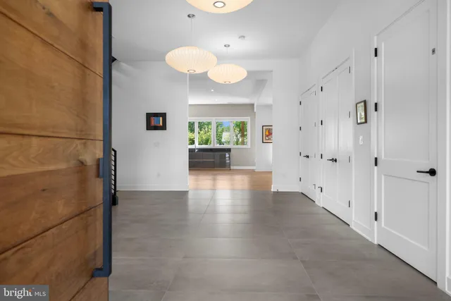 a view of a hallway view with wooden floor and staircase