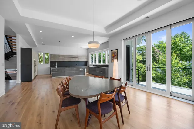 a dining room with furniture and wooden floor