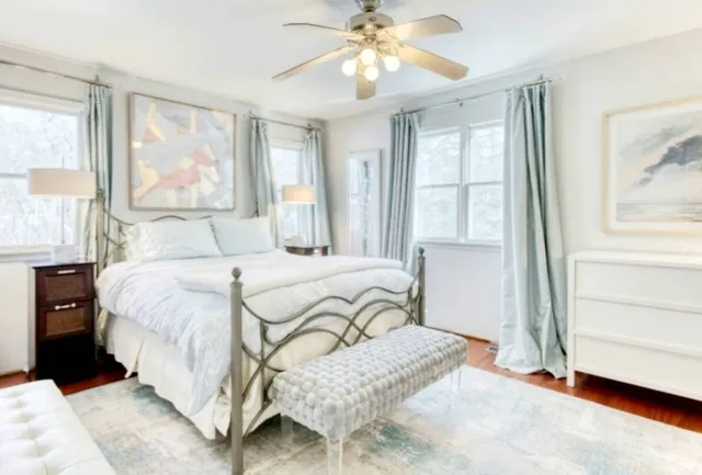 a bedroom with a large bed and a window