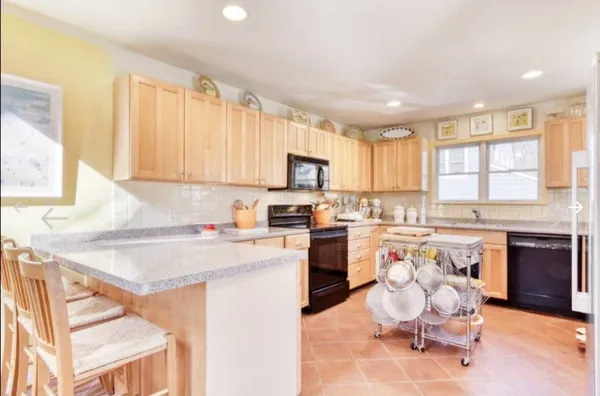 a kitchen with a refrigerator stove microwave and sink