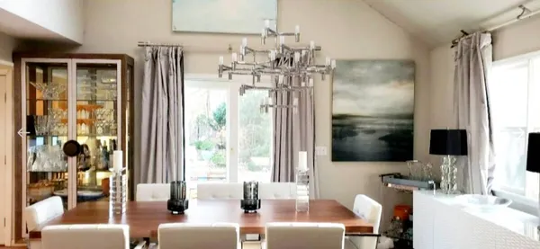 a very nice looking room with a large window and chandelier