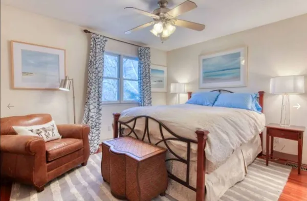 a bedroom with a bed couch and window