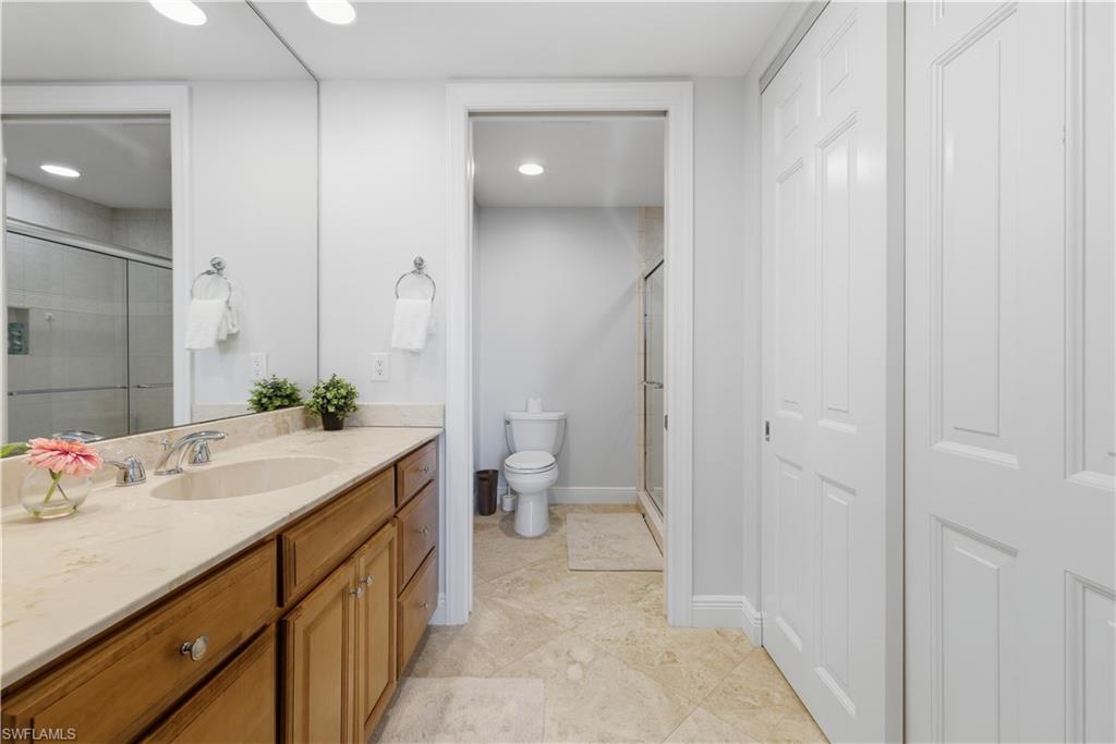 275 Indies Way, Unit 403 Naples, FL 34110 - Photo 17 of 50 a bathroom with a sink and a mirror