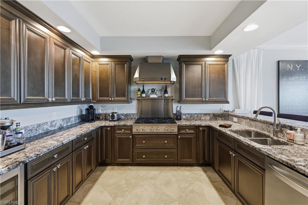 275 Indies Way, Unit 403 Naples, FL 34110 - Photo 18 of 50 a kitchen with stainless steel appliances granite countertop a sink stove and cabinets