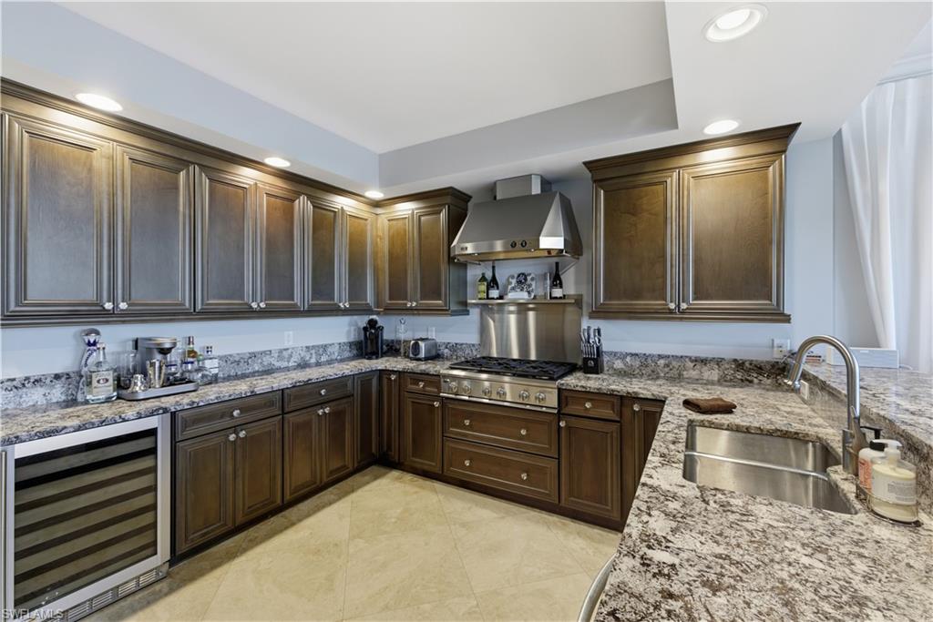 275 Indies Way, Unit 403 Naples, FL 34110 - Photo 20 of 50 a kitchen with a sink and cabinets