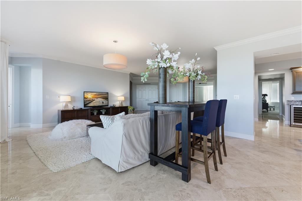 275 Indies Way, Unit 403 Naples, FL 34110 - Photo 24 of 50 a living room with furniture and a chandelier