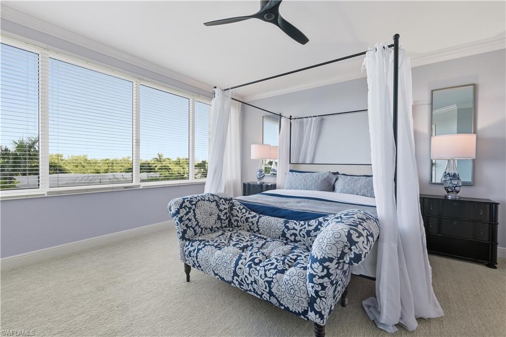 275 Indies Way, Unit 403 Naples, FL 34110 - Photo 28 of 50 a bed room with a bed and a couch