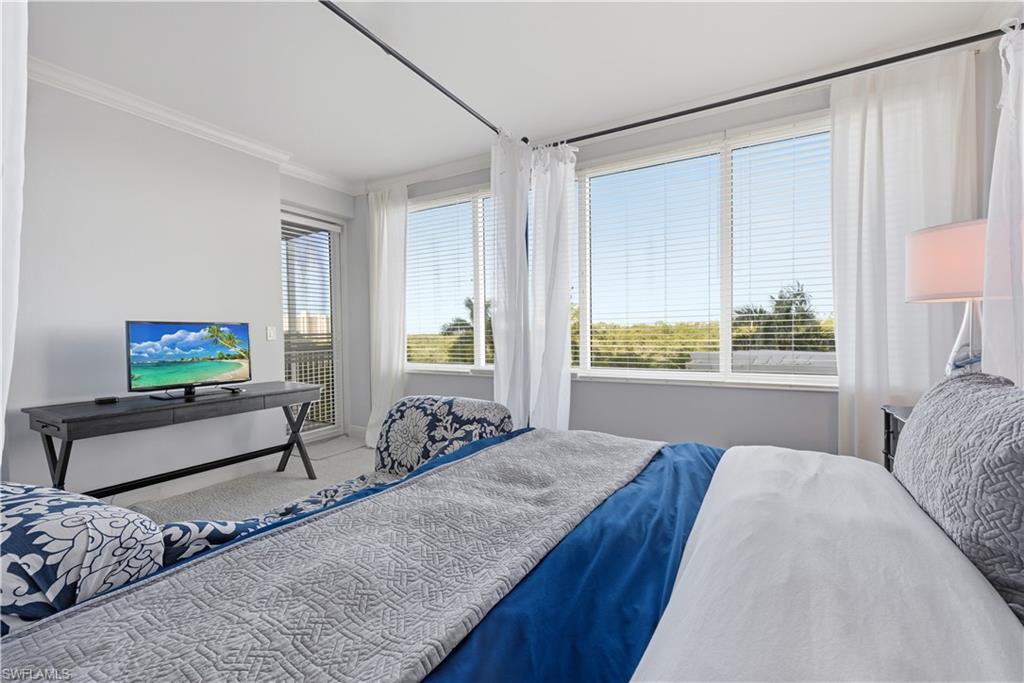 275 Indies Way, Unit 403 Naples, FL 34110 - Photo 30 of 50 a bedroom with a bed and a window