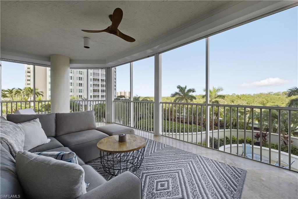 275 Indies Way, Unit 403 Naples, FL 34110 - Photo 35 of 50 a living room with furniture and a floor to ceiling window