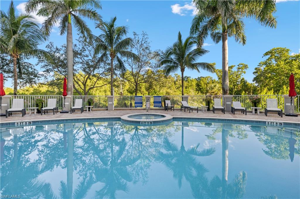 275 Indies Way, Unit 403 Naples, FL 34110 - Photo 40 of 50 a view of swimming pool with a table and chairs