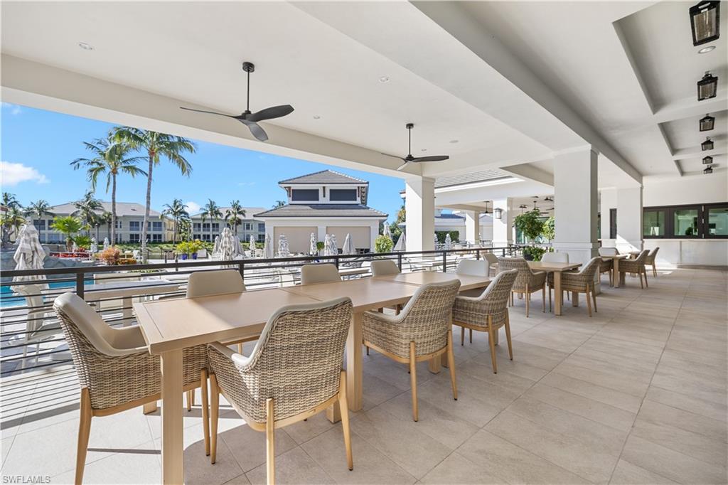 275 Indies Way, Unit 403 Naples, FL 34110 - Photo 43 of 50 a dining area with furniture and a chandelier