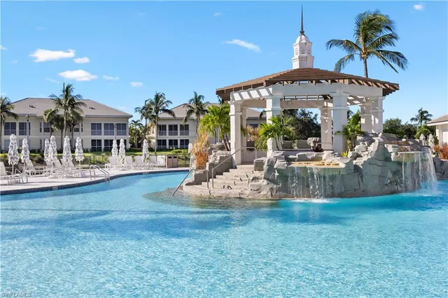a view of a house with swimming pool and sitting area