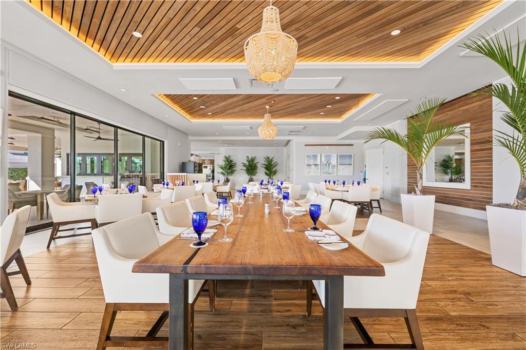 275 Indies Way, Unit 403 Naples, FL 34110 - Photo 48 of 50 a view of a dining room with furniture window and outside view