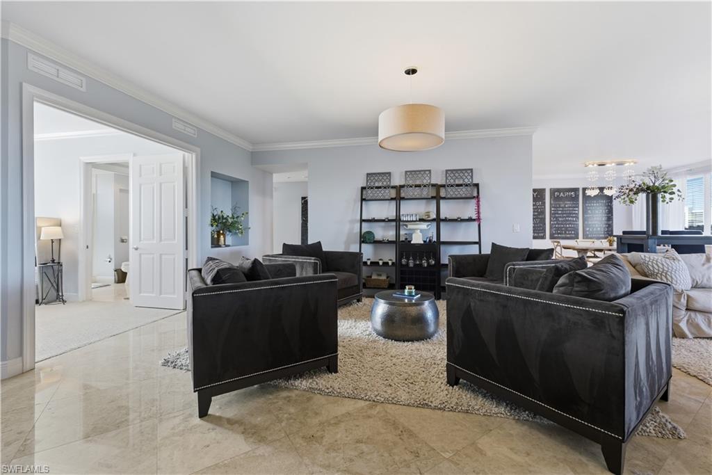275 Indies Way, Unit 403 Naples, FL 34110 - Photo 5 of 50 a living room with furniture a dining table and chairs