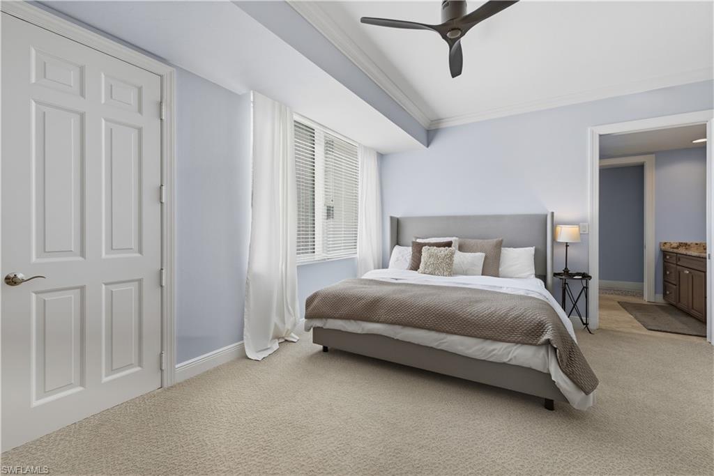 275 Indies Way, Unit 403 Naples, FL 34110 - Photo 7 of 50 a bedroom with a bed and painted walls