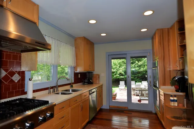 a kitchen with lots of counter top space and wooden floor