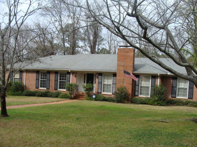 1844 Lincoln Road Macon, GA 31211 - Photo 1 of 1 a front view of a house with a garden and trees