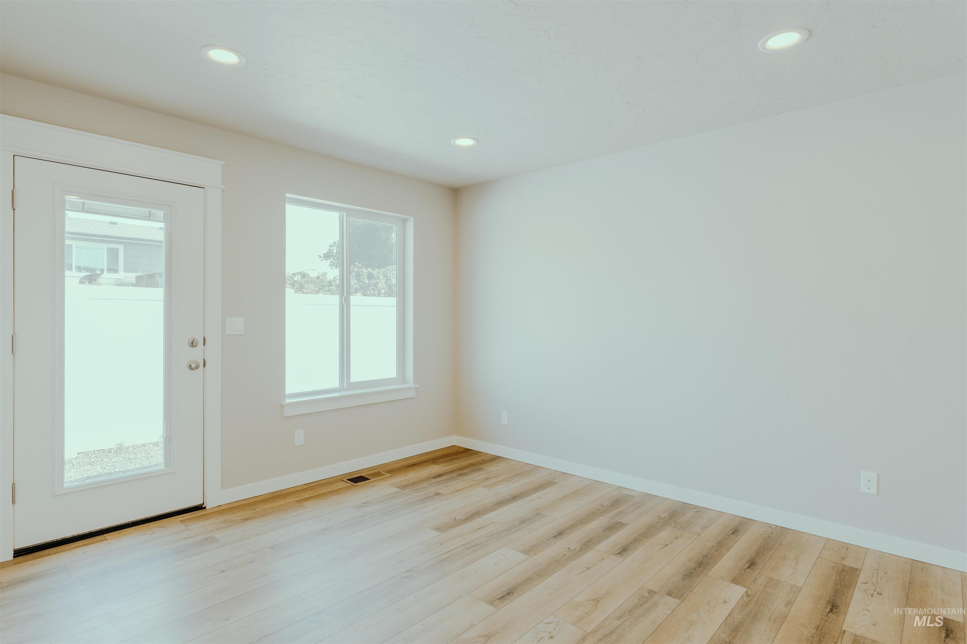 1233 Phillips Circle Ontario, OR 97914 - Photo 11 of 22 Empty room with recessed lighting and light wood finished floors