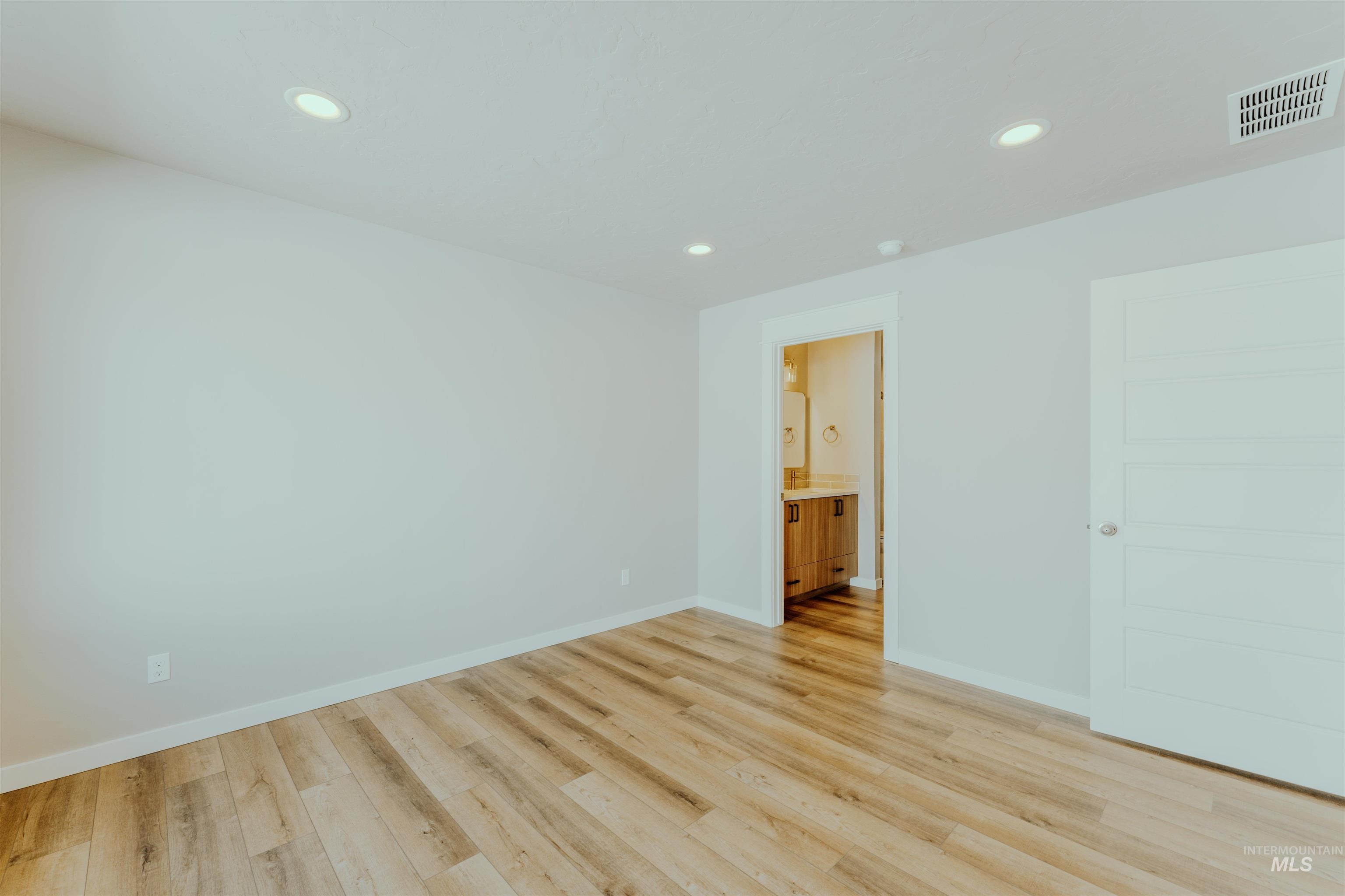 1233 Phillips Circle Ontario, OR 97914 - Photo 12 of 22 Empty room featuring recessed lighting and light wood-style floors
