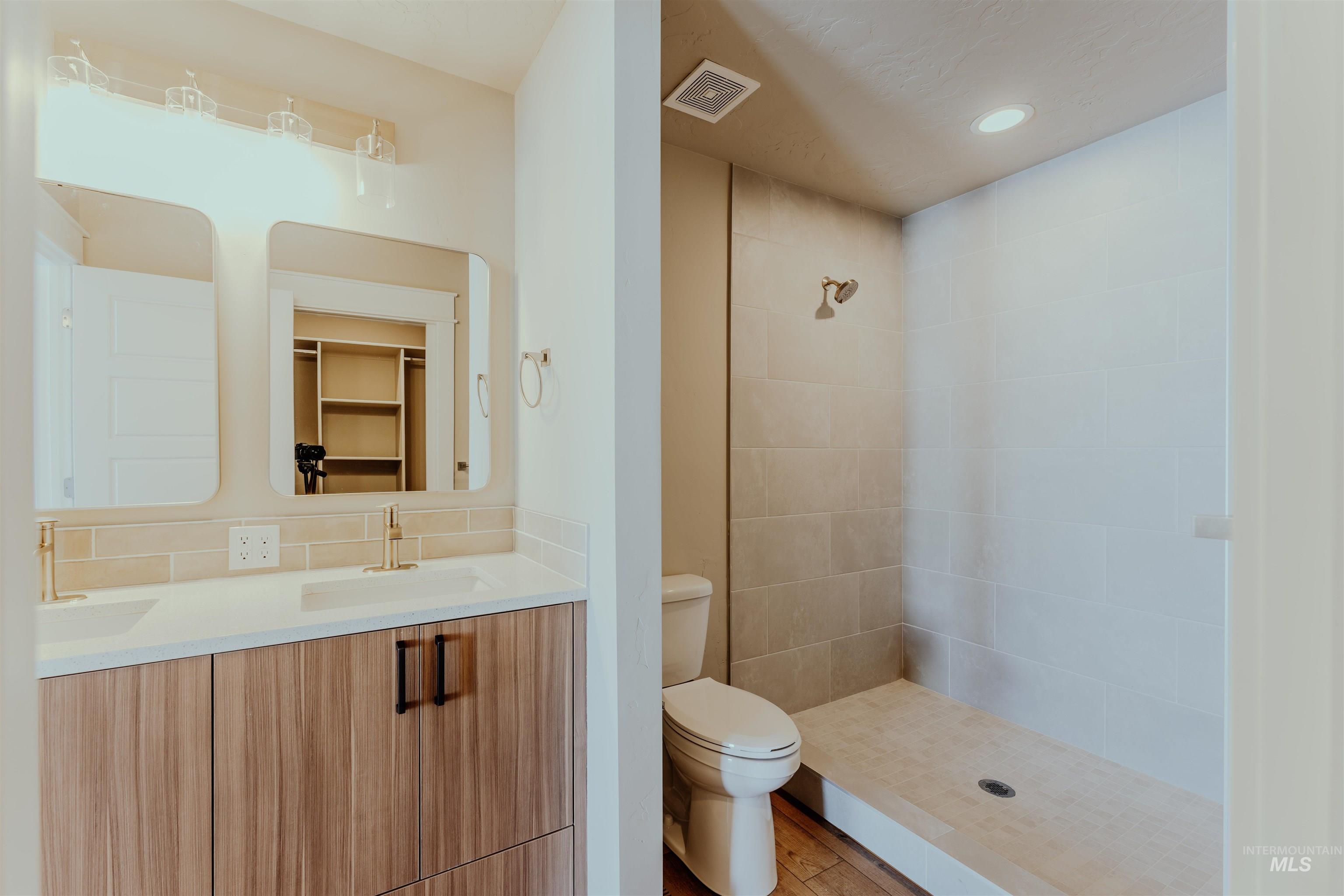 1233 Phillips Circle Ontario, OR 97914 - Photo 14 of 22 Full bathroom featuring a spacious closet, double vanity, a shower stall, and recessed lighting