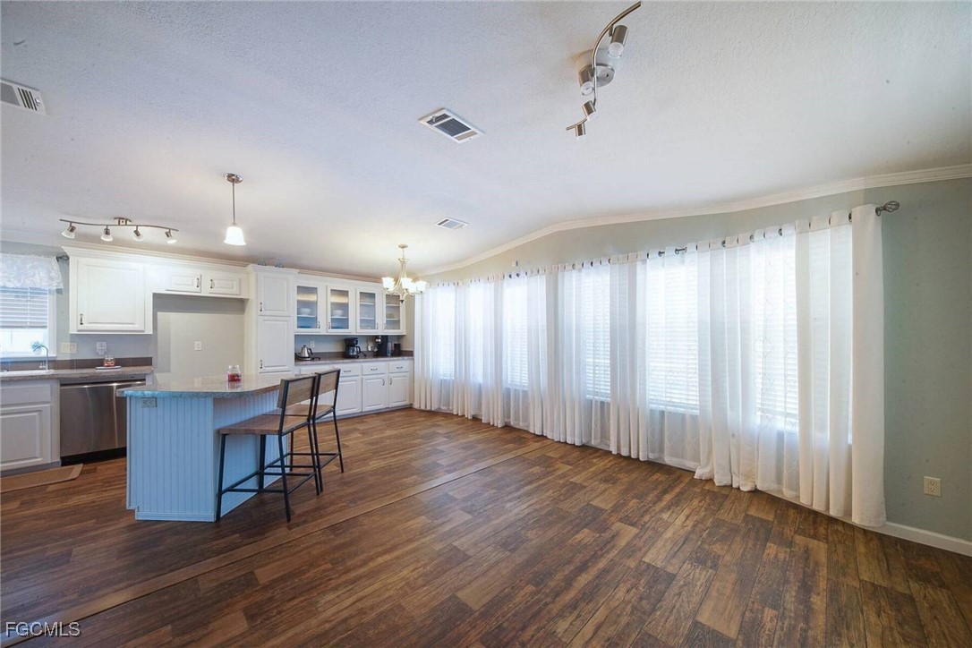2831 York Road St. James City, FL 33956 - Photo 16 of 29 a view of a kitchen with furniture and wooden floor