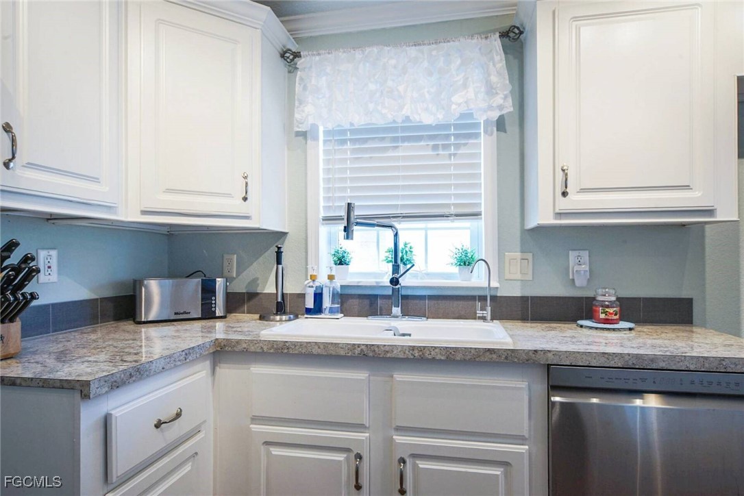 2831 York Road St. James City, FL 33956 - Photo 19 of 29 a kitchen with granite countertop a sink and a window