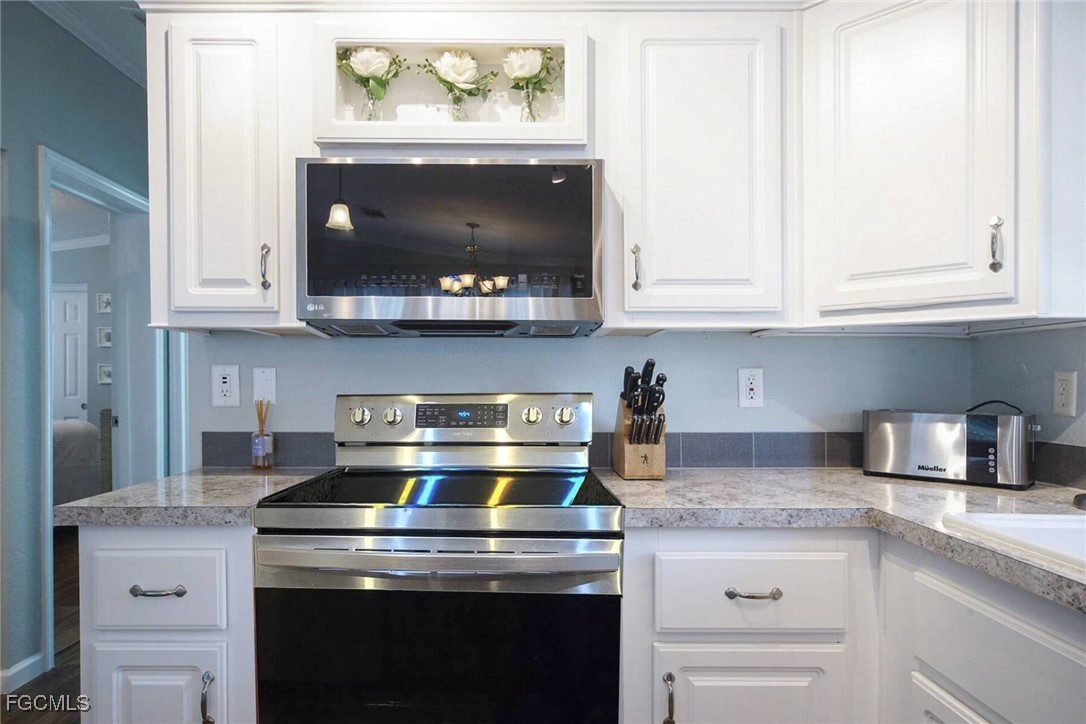 2831 York Road St. James City, FL 33956 - Photo 20 of 29 a stove top oven sitting inside of a kitchen