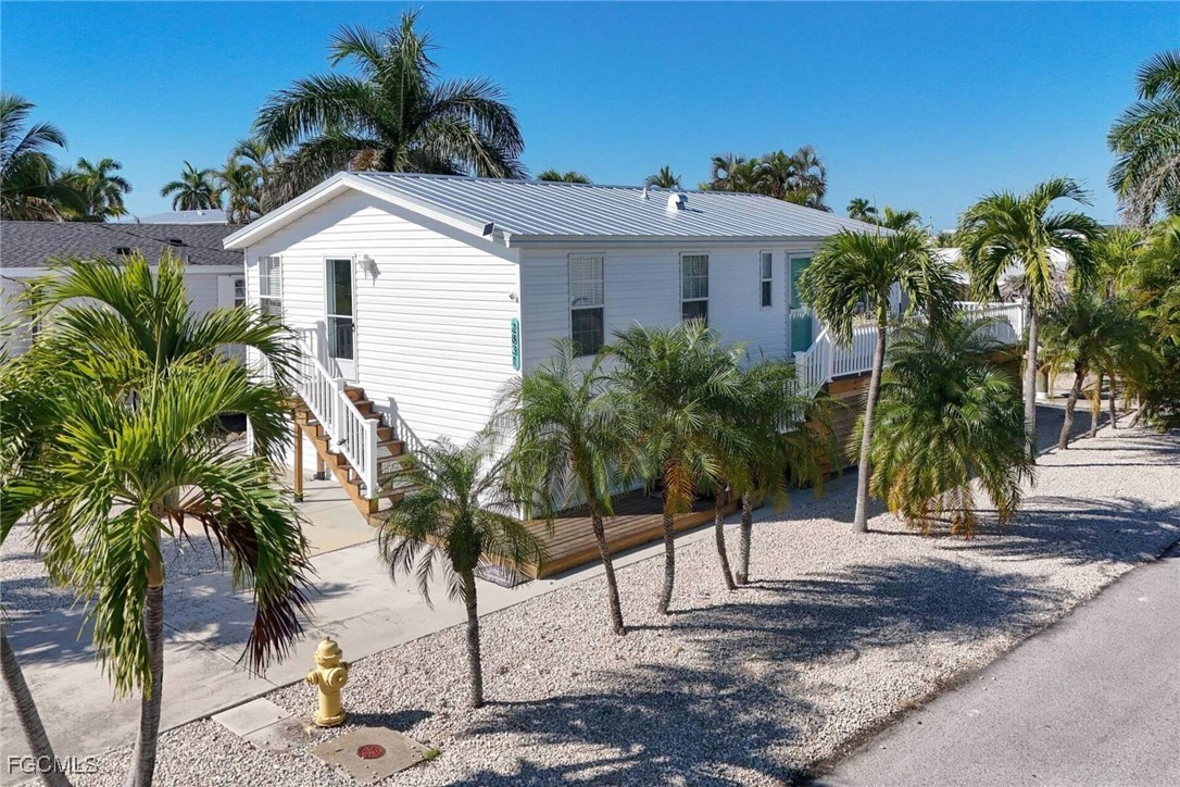 2831 York Road St. James City, FL 33956 - Photo 2 of 29 a view of a house with a yard and palm trees