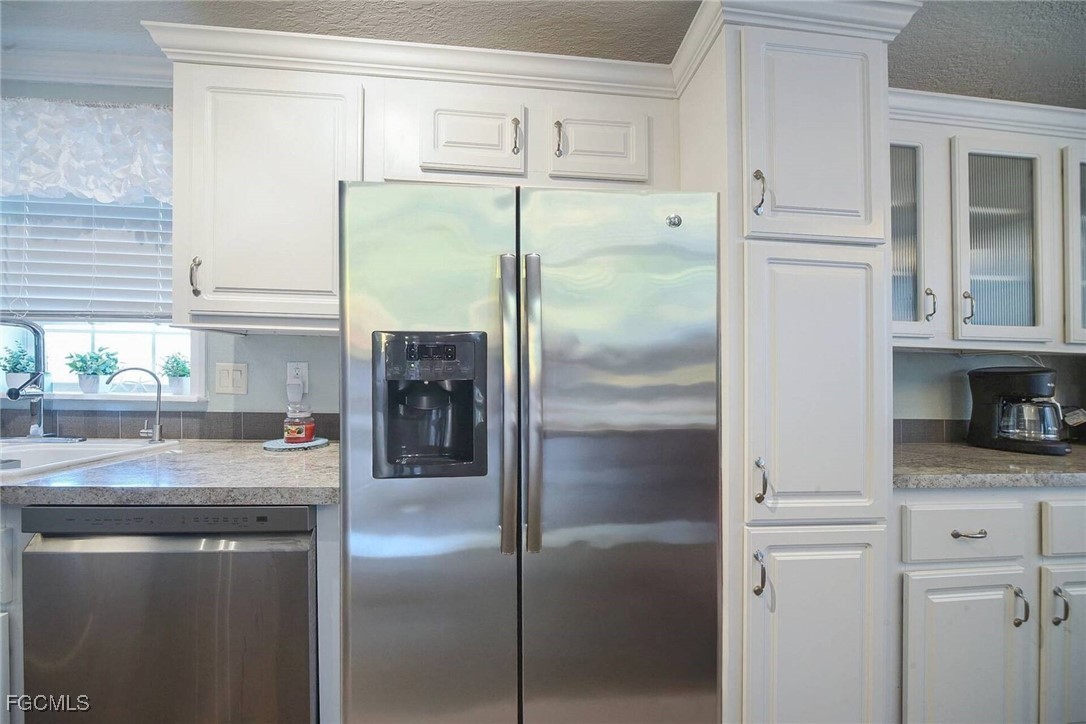 2831 York Road St. James City, FL 33956 - Photo 21 of 29 a kitchen with stainless steel appliances granite countertop a refrigerator and a sink