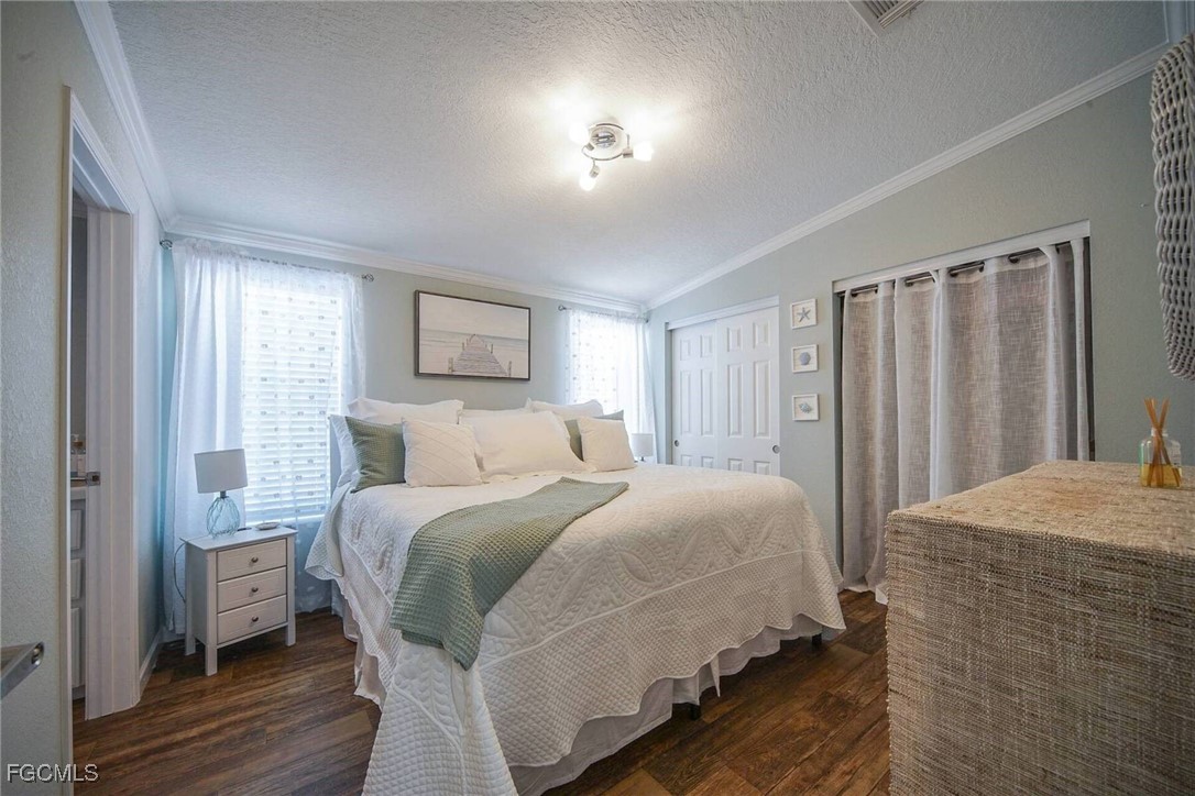 2831 York Road St. James City, FL 33956 - Photo 24 of 29 a bedroom with a bed and a refrigerator