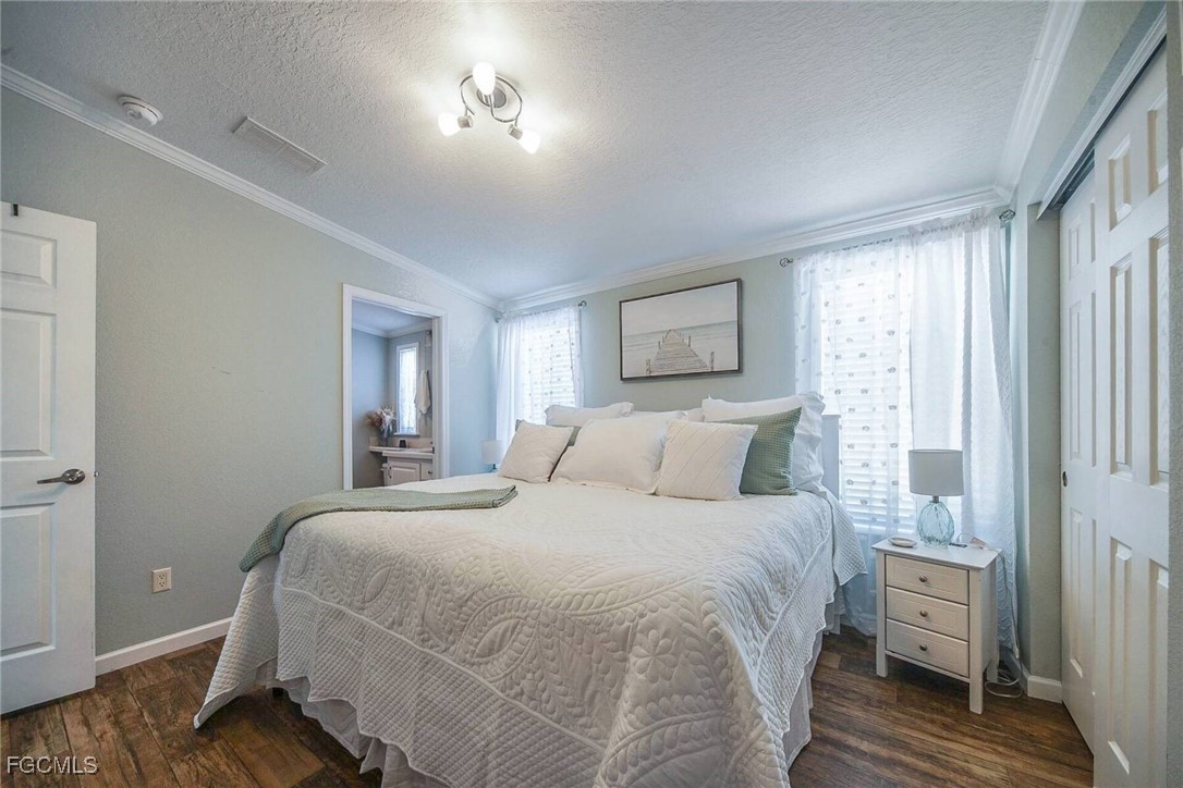 2831 York Road St. James City, FL 33956 - Photo 25 of 29 a bedroom with a bed and wooden floor