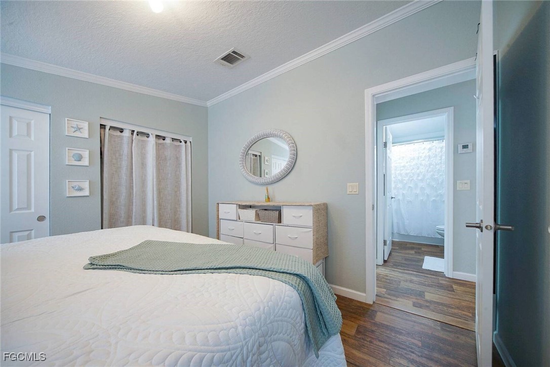 2831 York Road St. James City, FL 33956 - Photo 26 of 29 a bedroom with a bed and a chandelier