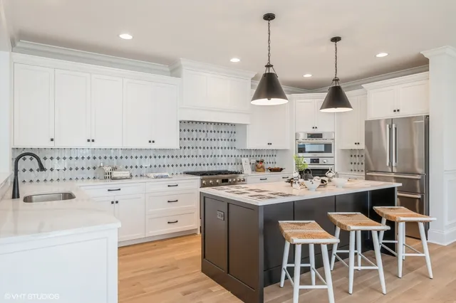 a kitchen with a sink stove and wooden floor