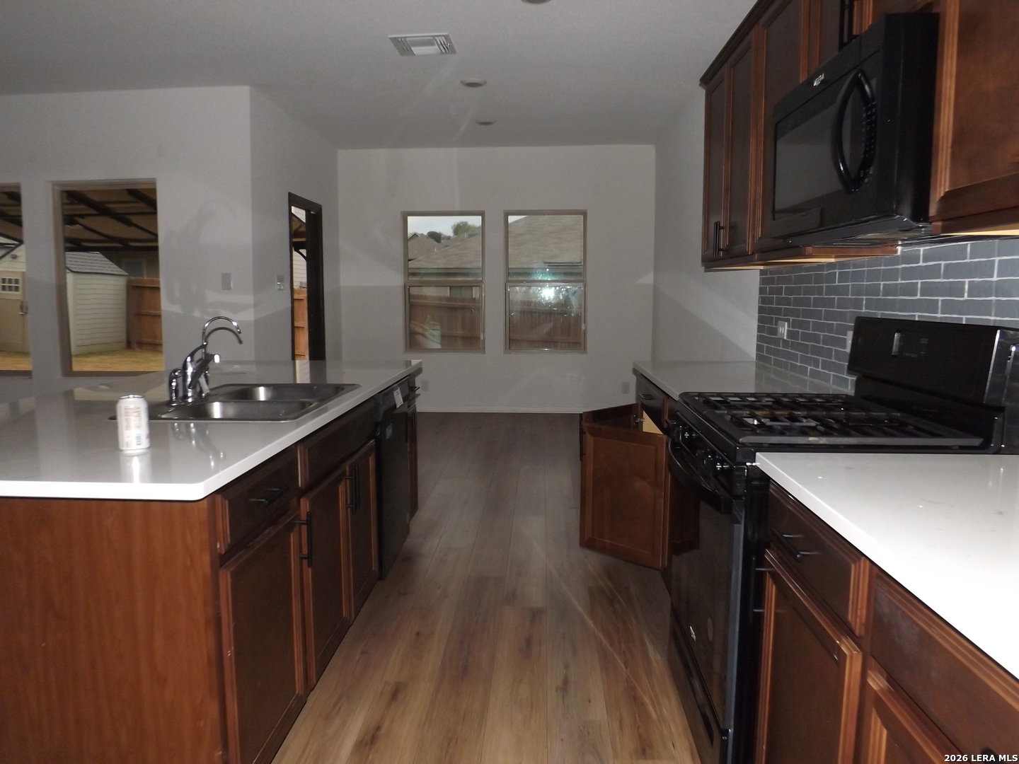 6835 Alaskan Wy. Converse, TX 78109 - Photo 2 of 22 a kitchen with stainless steel appliances granite countertop a sink stove and cabinets