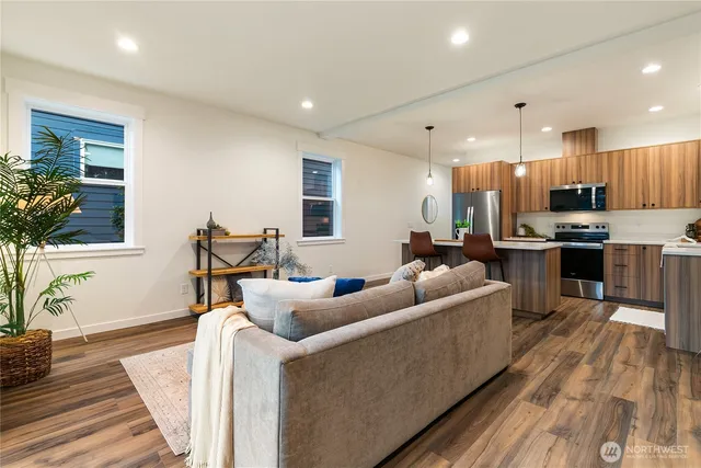 a living room with furniture and a wooden floor