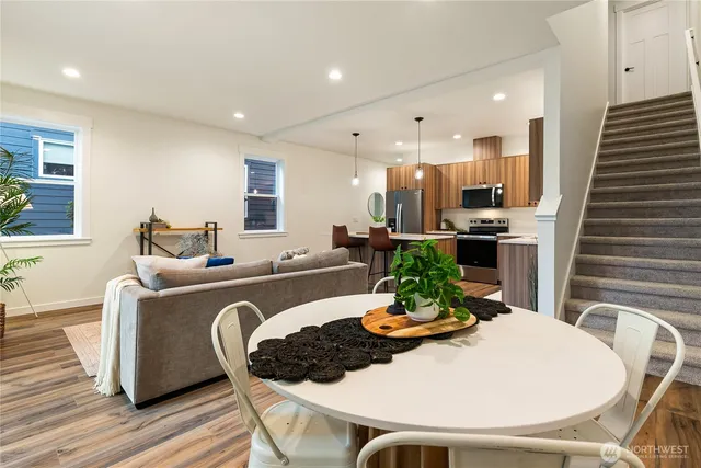 a dining room with furniture and wooden floor