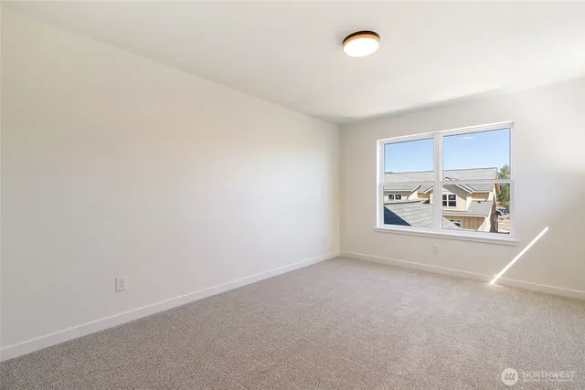 an empty room with furniture and window