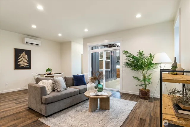 a living room with furniture and a potted plant