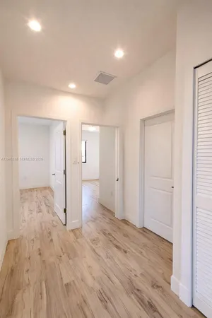 a view of an empty room with glass door