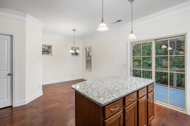 a kitchen with a counter space and a wooden floor